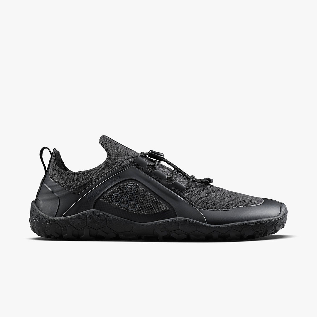Side view on white background of Mens Vivobarefoot Primus Trail Knit FG running shoe in Obsidian, Medium (Regular) width