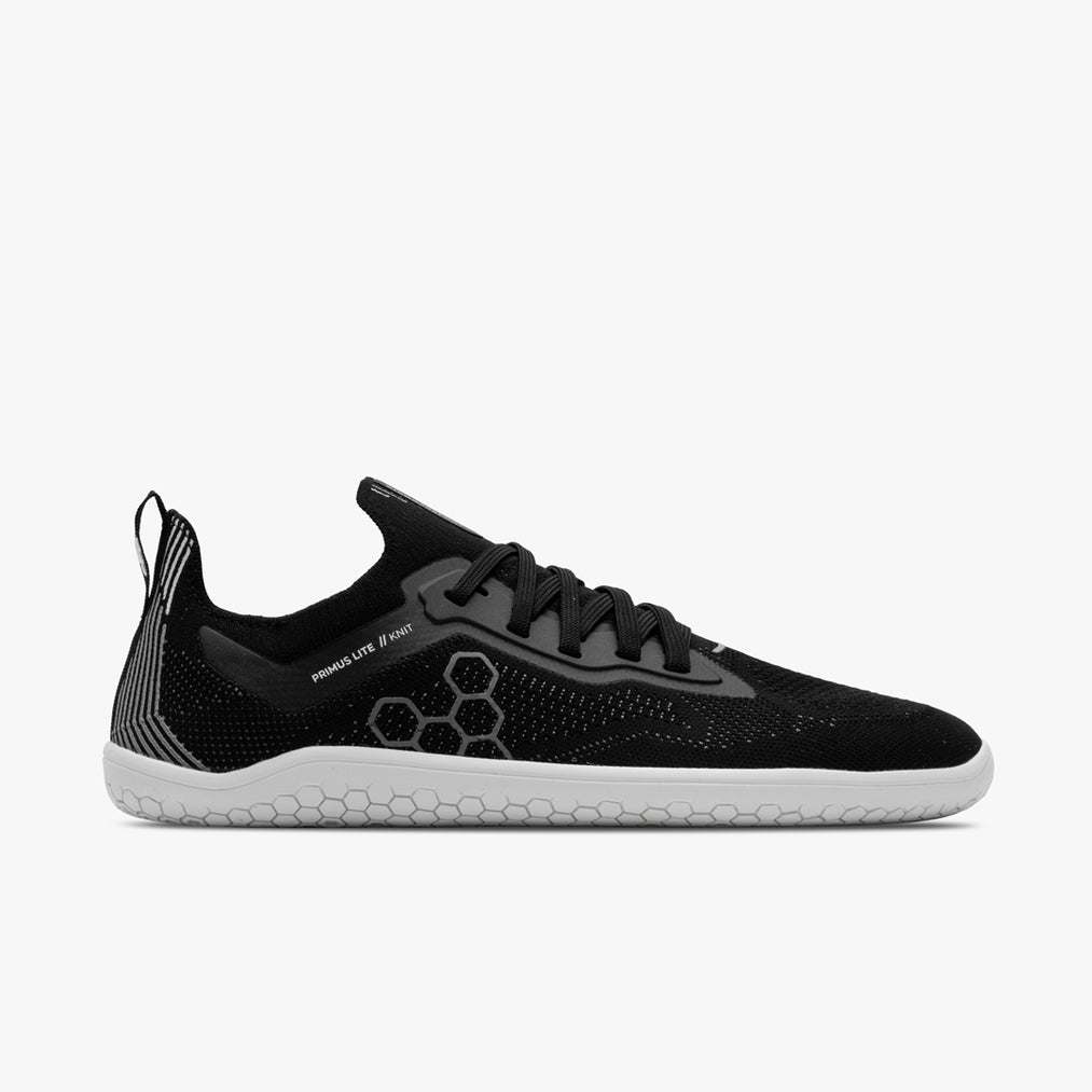 Side view on white background of Mens Vivobarefoot Primus Lite Knit running shoe in Obsidian, Medium (Regular) width