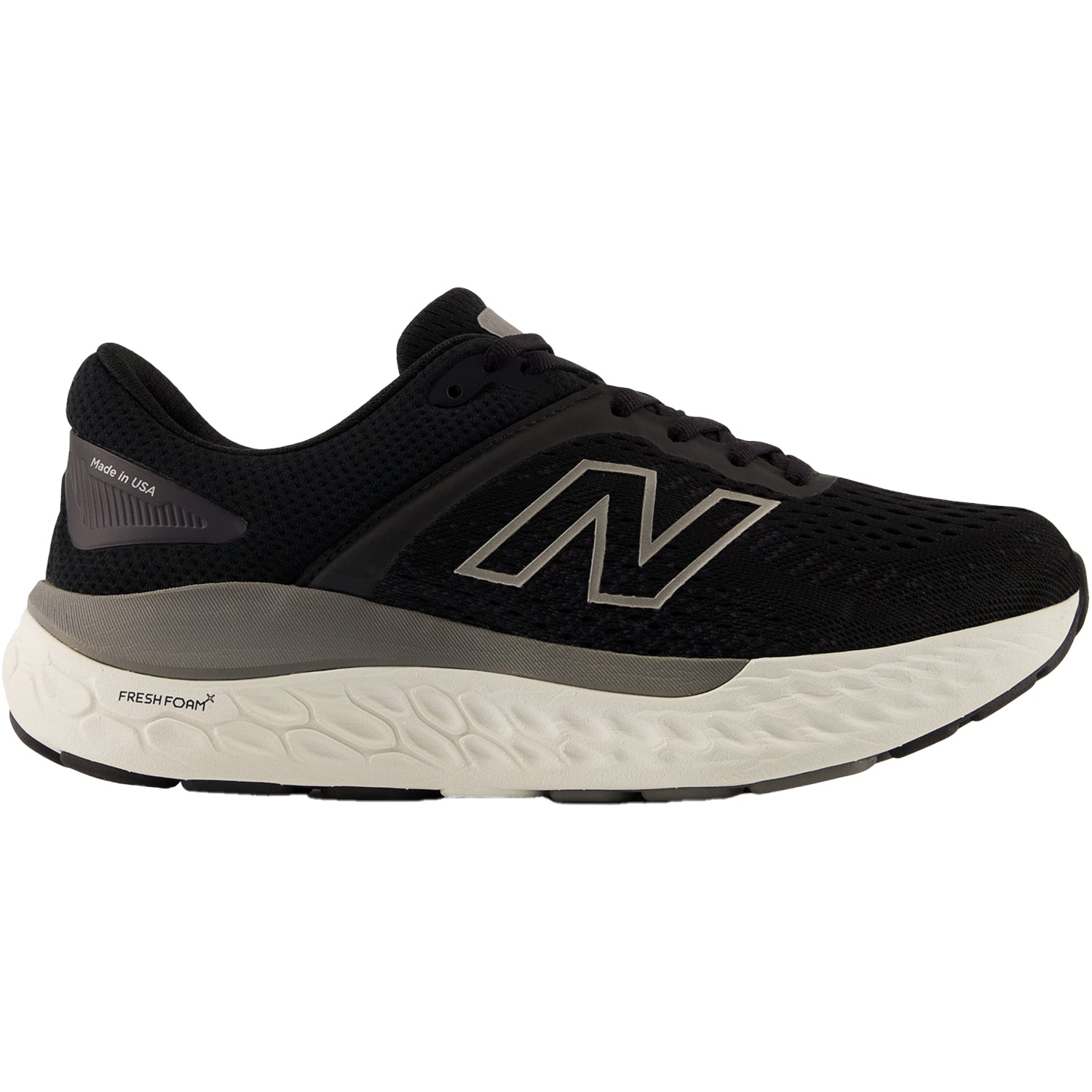 Side view on white background of Womens New Balance 1540v4 running shoe in Black/White, Wide width