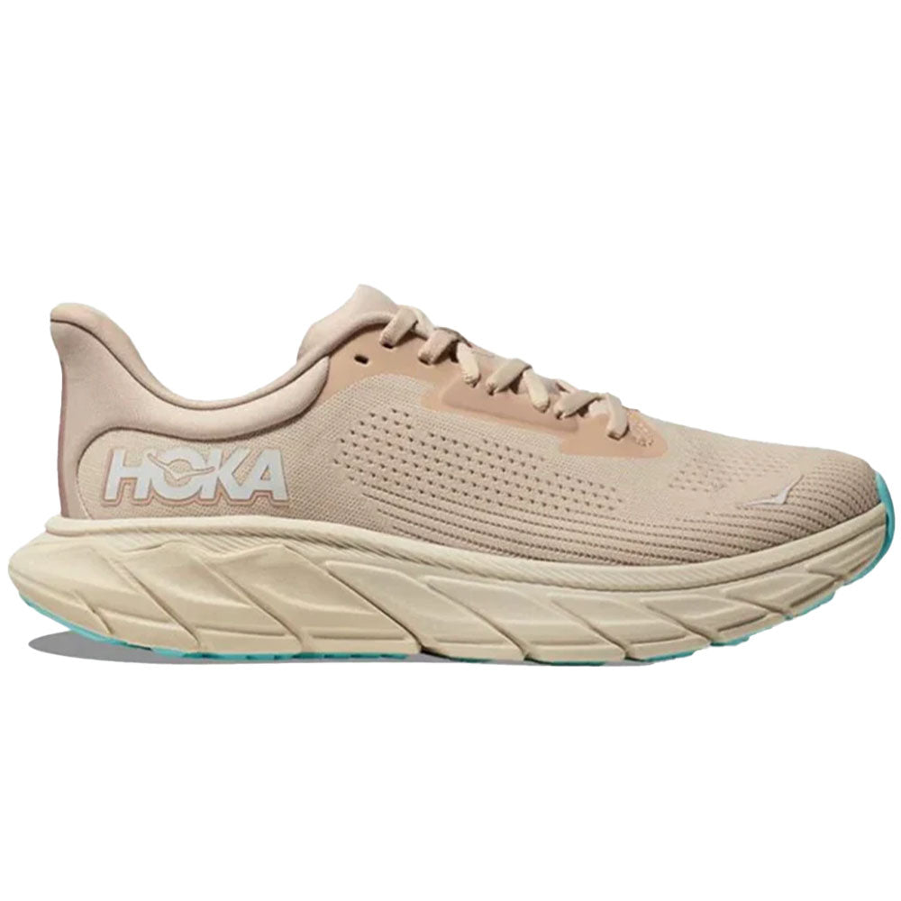 Side view on white background of Womens Hoka Arahi running shoe in Vanilla/Cream, Wide width