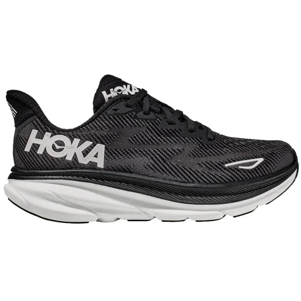 Side view on white background of Mens Hoka Clifton running shoe in Black/White, Wide width