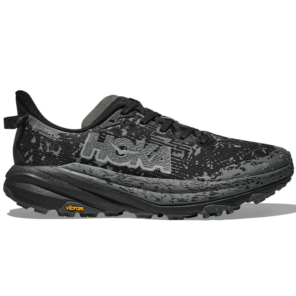 Side view on white background of Mens Hoka Speedgoat running shoe in Black/Outer Orbit, Wide width