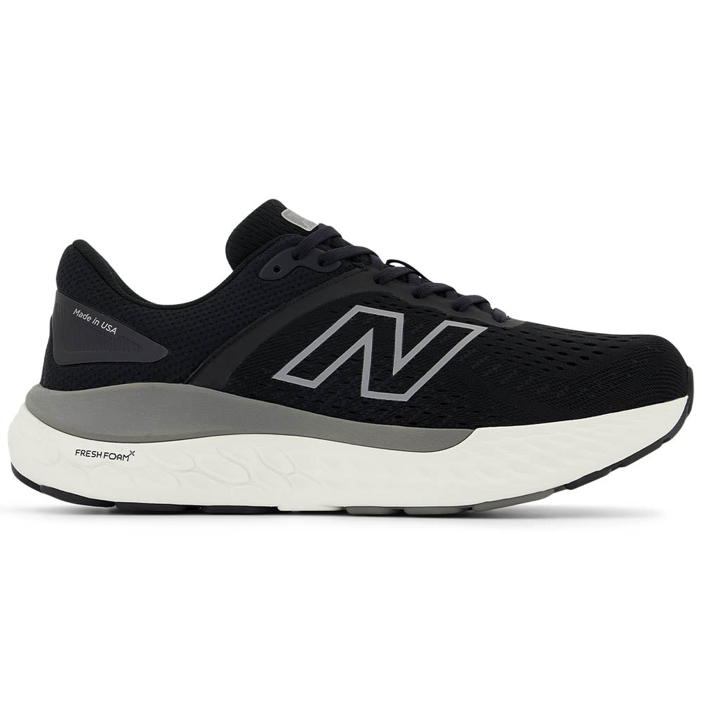 Side view on white background of Mens New Balance 1540 running shoe in Black/Harbor Gray, Wide width