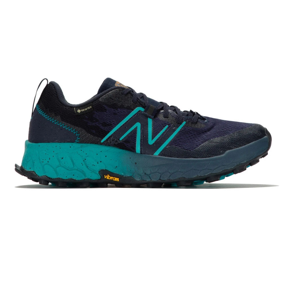 Side view on white background of Womens New Balance Fresh Foam X Hierro V7 GTX running shoe in Natural Indigo/Eclipse/Electric Teal, Medium (Regular) width