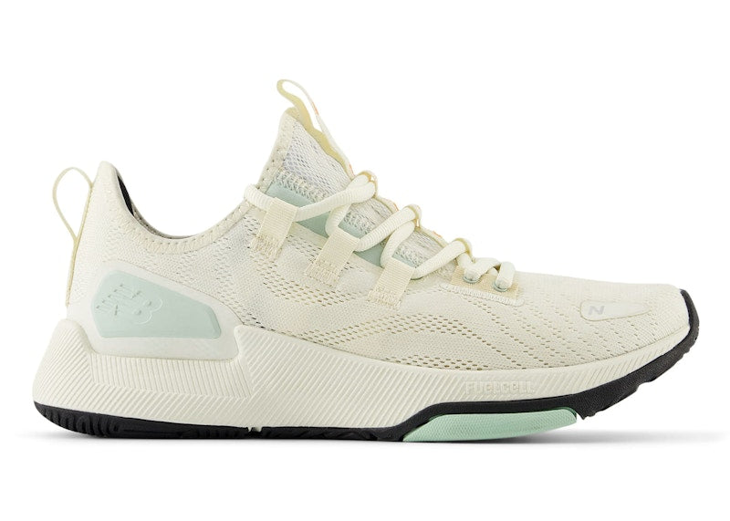 Side view on white background of Womens New Balance FuelCell Trainer v2 running shoe in Angora/Calcium/Clay Ash/Sizzle, Medium (Regular) width
