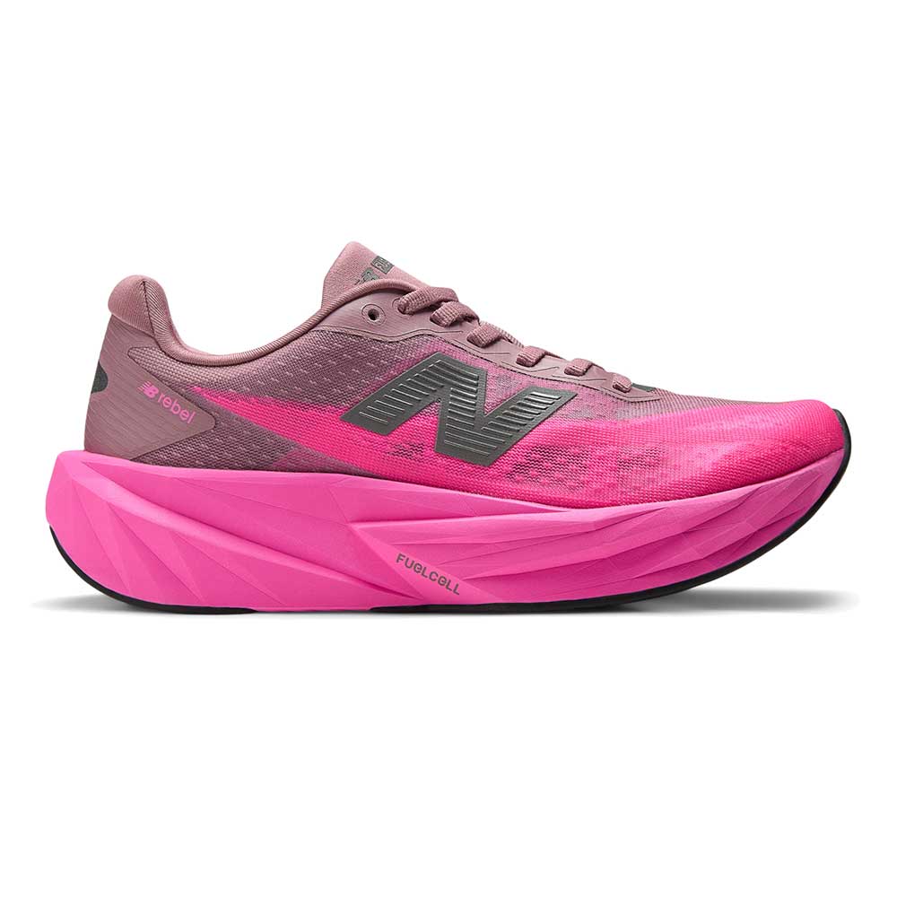 Side view on white background of Womens New Balance FuelCell Rebel v5 running shoe in Pinkheat/Rosewood, Wide width