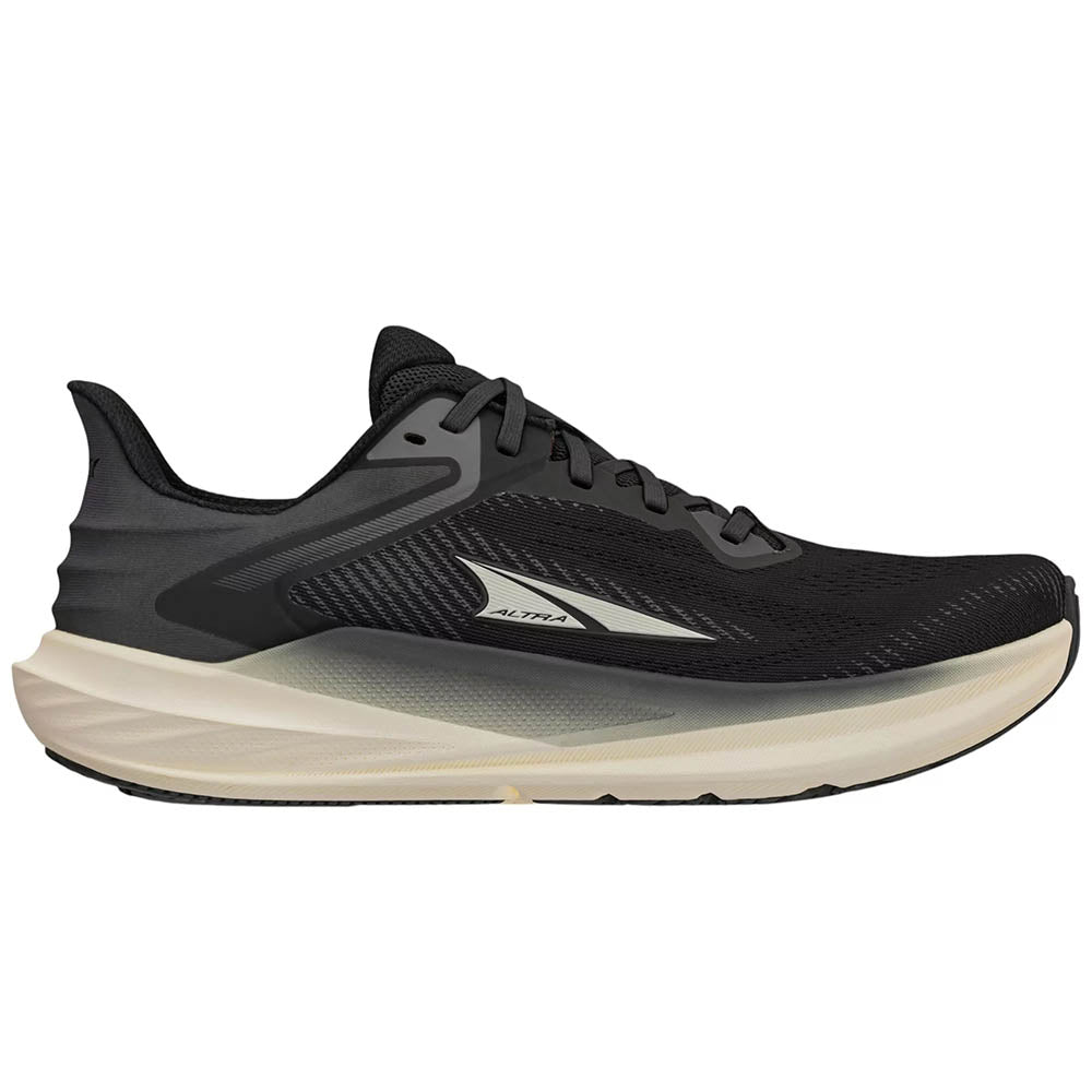 Side view on white background of Womens Altra Torin running shoe in Black/White, Medium (Regular) width