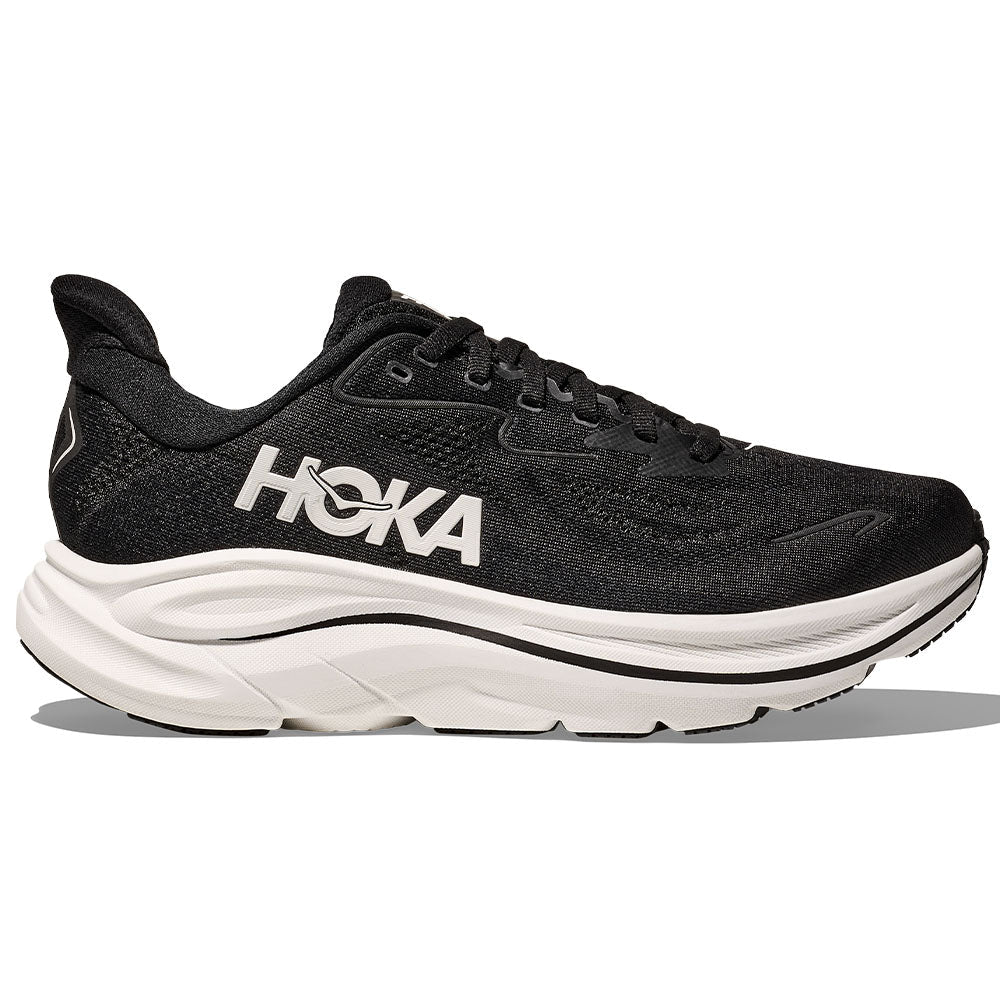 Side view on white background of Womens Hoka Clifton running shoe in Black/White, Medium (Regular) width