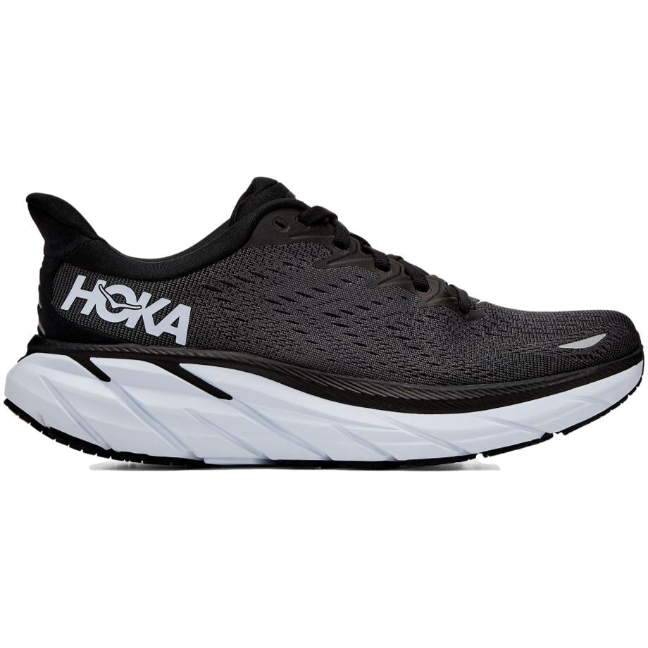 Side view on white background of Womens Hoka Clifton running shoe in Black/White, Wide width