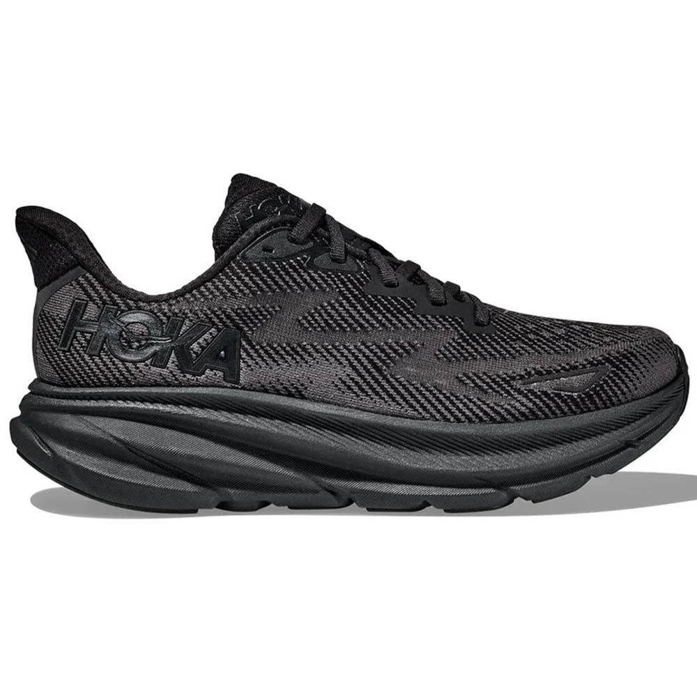 Side view on white background of Womens Hoka Clifton running shoe in Black/Black, Medium (Regular) width