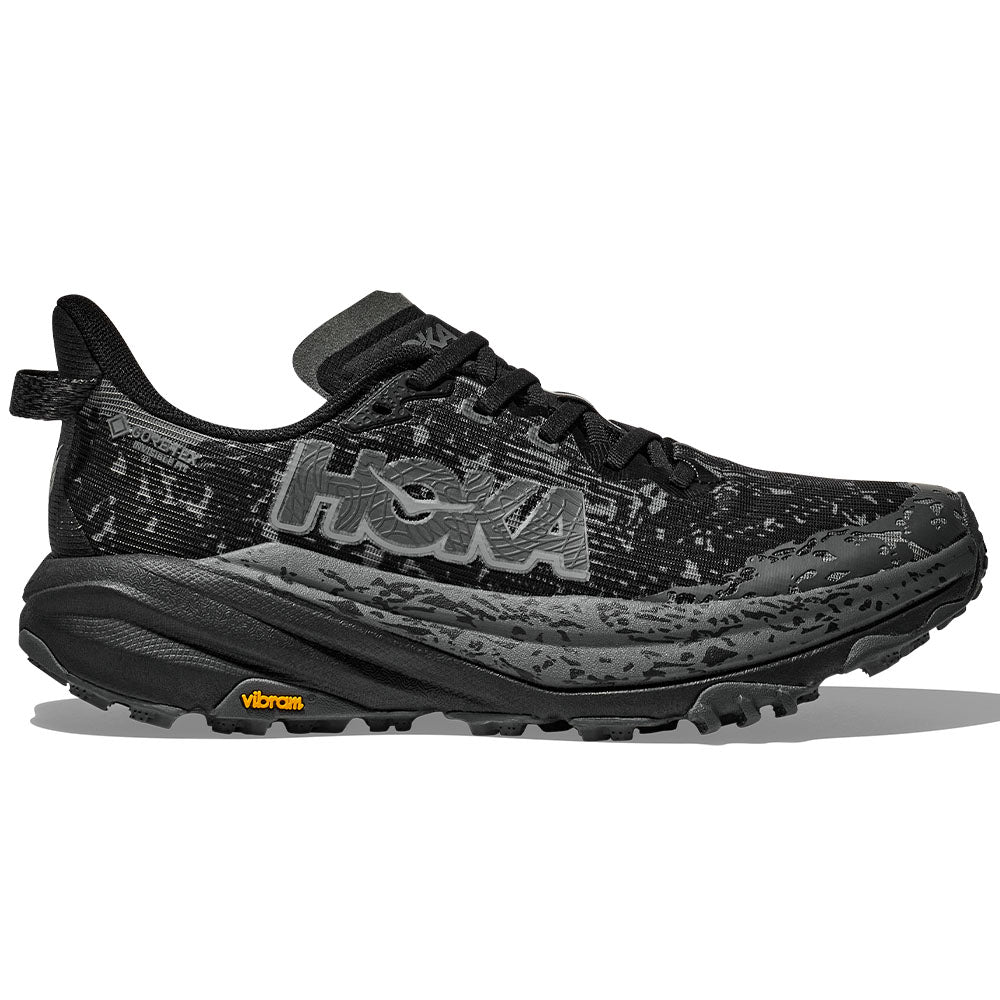 Side view on white background of Womens Hoka Speedgoat running shoe in Black/Outer Orbit, Medium (Regular) width