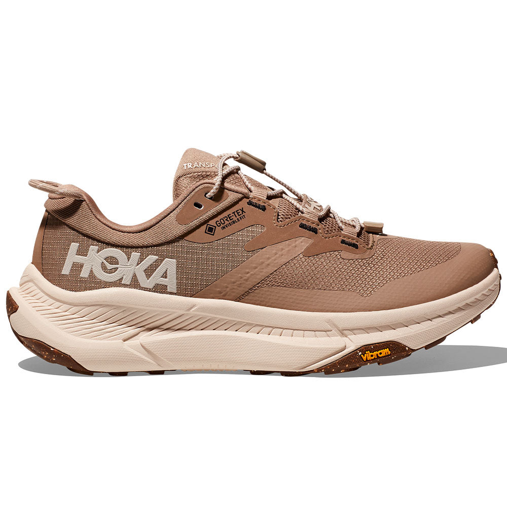 Side view on white background of Womens Hoka Transport running shoe in Dune/Eggnog, Medium (Regular) width