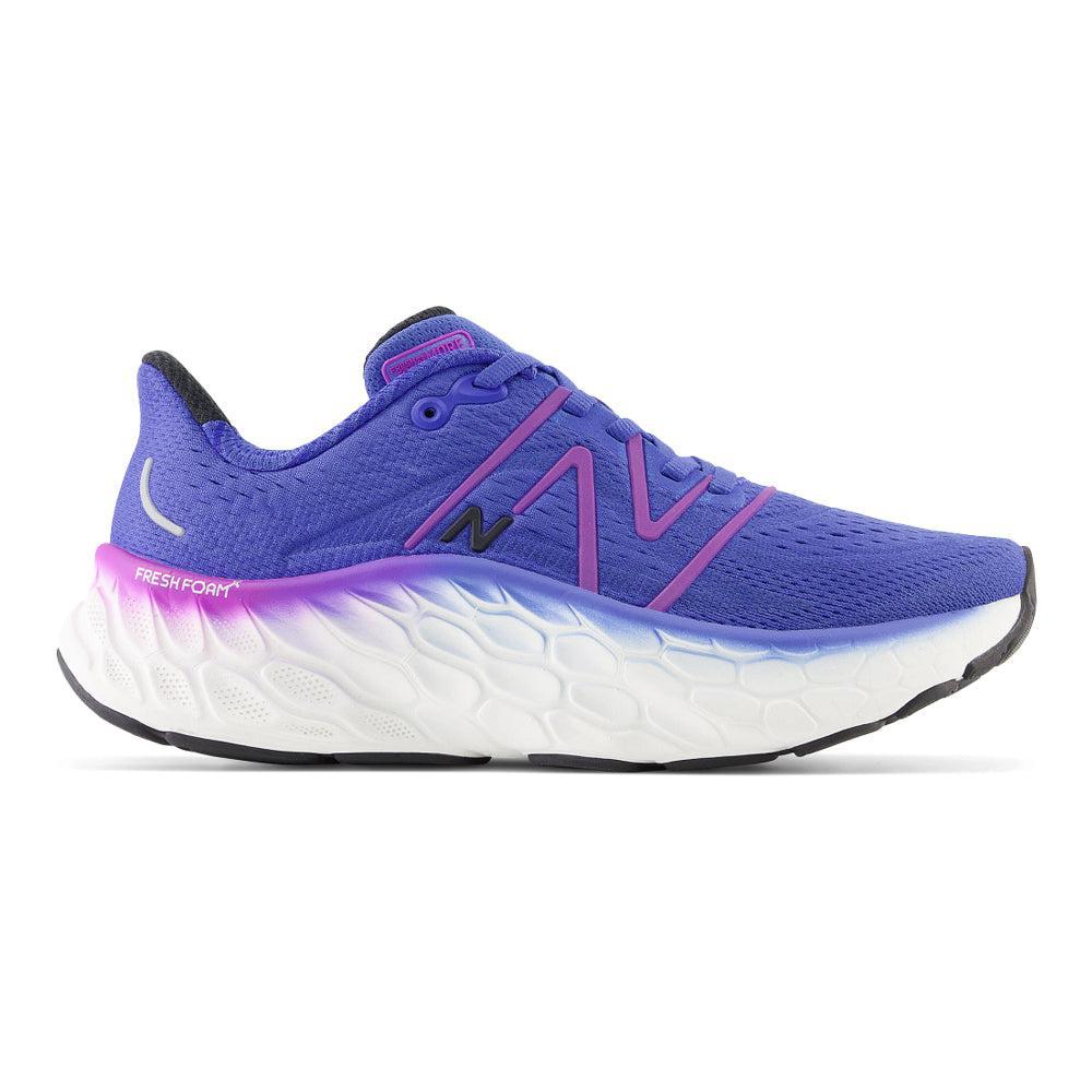 Side view on white background of Womens New Balance Fresh Foam More running shoe in Marine Blue/Cosmic Rose, Medium (Regular) width