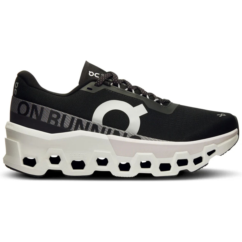 Side view on white background of Womens On Cloudmonster running shoe in Black/Frost, Medium (Regular) width
