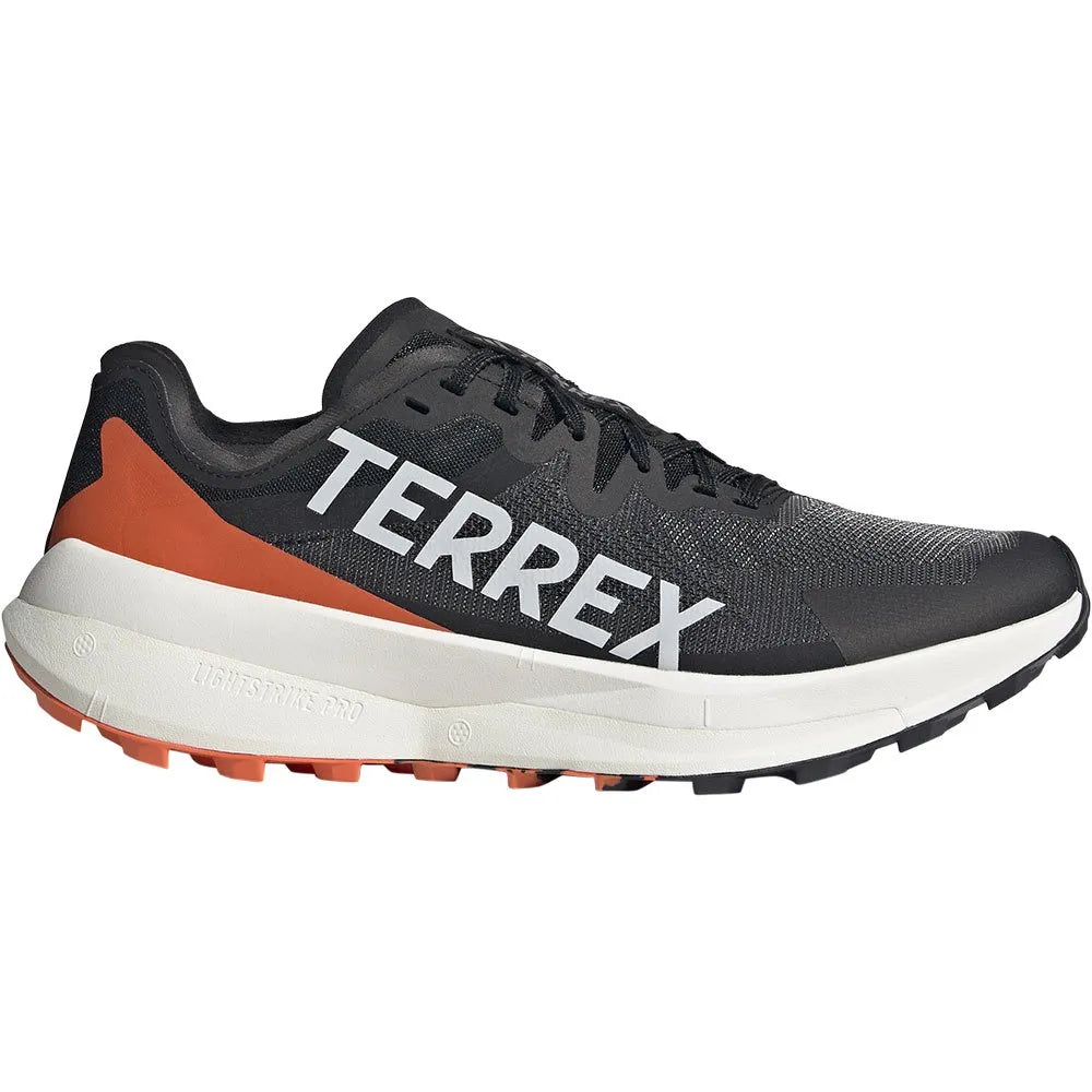Side view on white background of Mens Adidas Terrex Agravic Speed running shoe in Core Black/Grey One/Amber Tint , Medium (Regular) width
