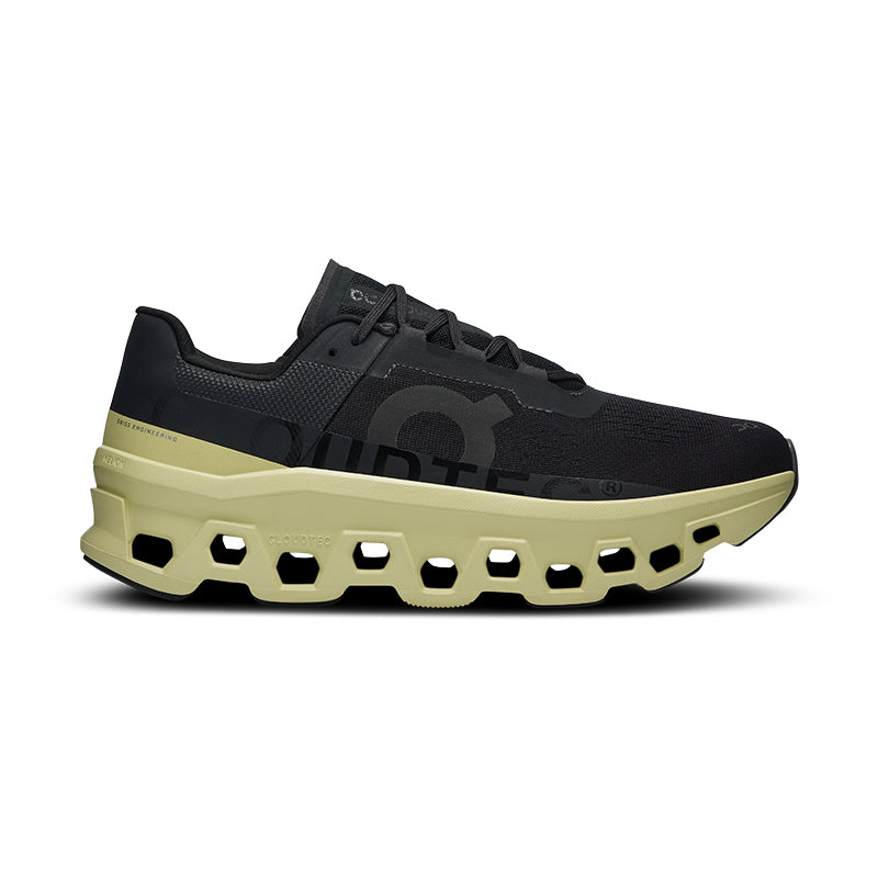 Side view on white background of Mens On Cloudmonster running shoe in Black/Acacia, Medium (Regular) width