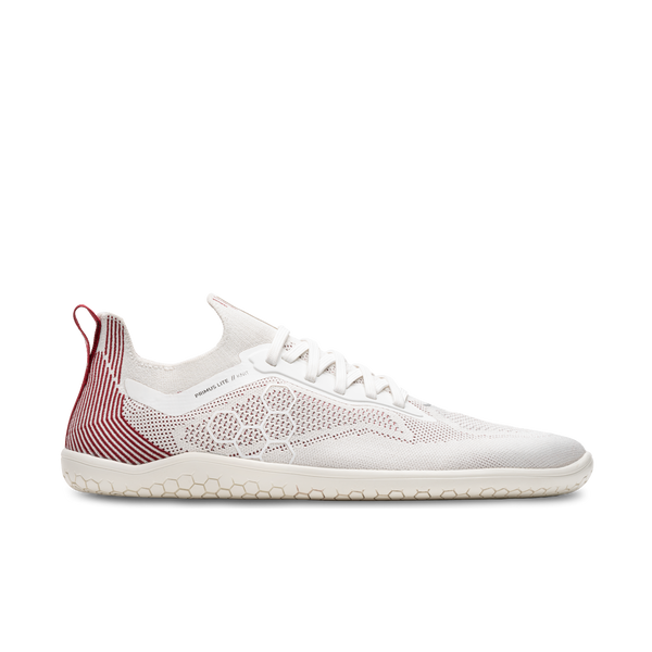 Side view on white background of Womens Vivobarefoot Primus Lite Knit running shoe in Off White/Burgundy, Medium (Regular) width