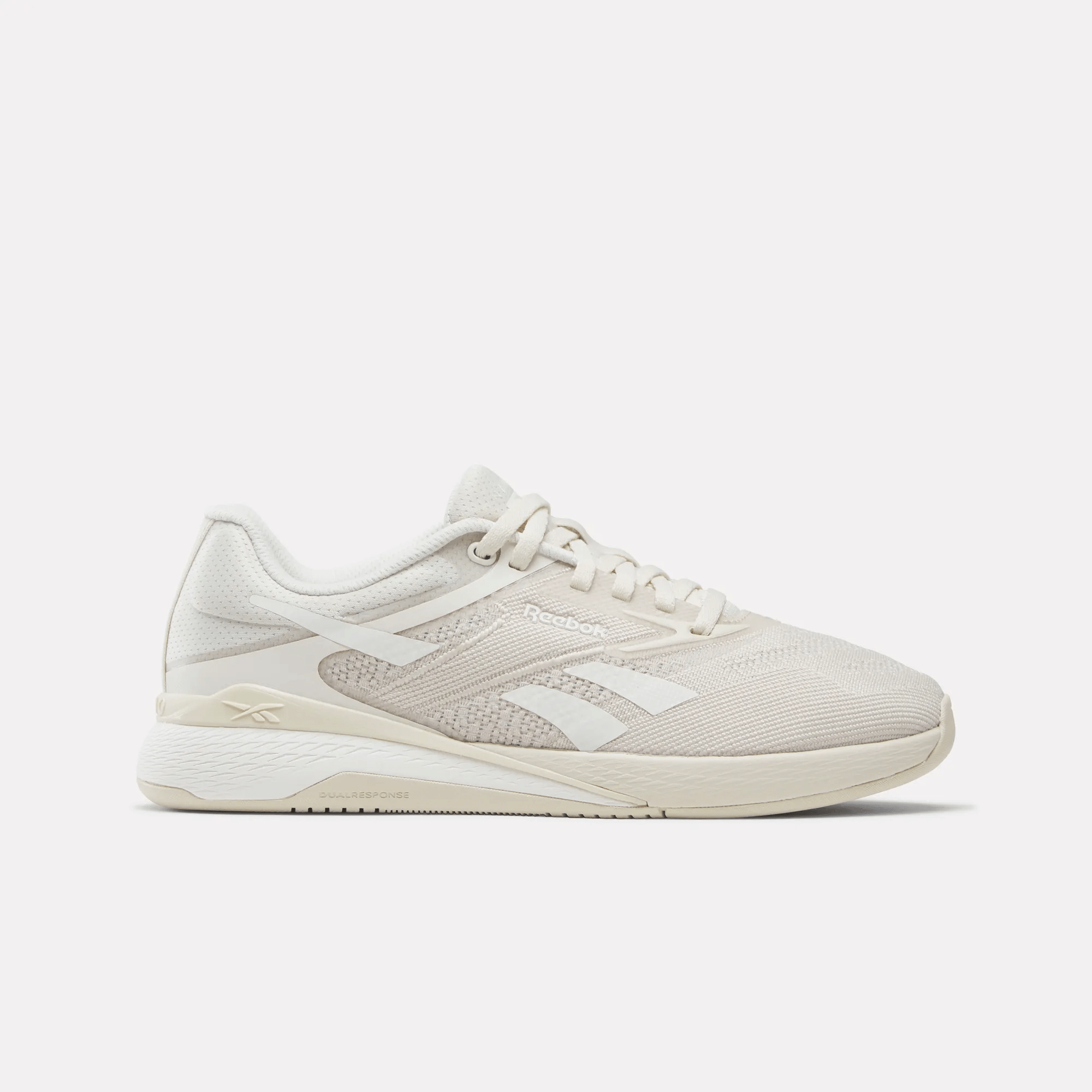 Side view on white background of Womens Reebok Nano X5 running shoe in Sand/Chalk, Medium (Regular) width