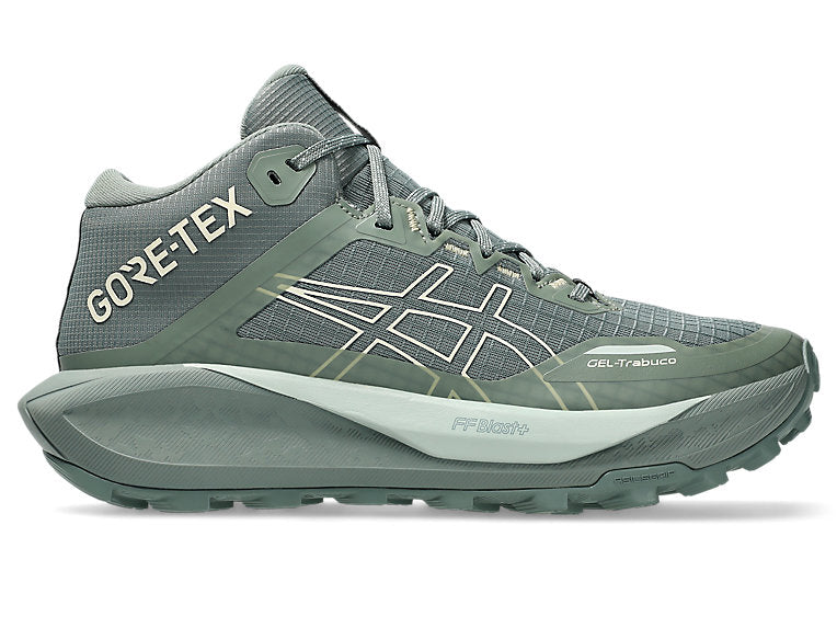 Side view on white background of Womens Asics Gel-Trabuco MT GTX running shoe in Monument Blue/Vanilla, Medium (Regular) width