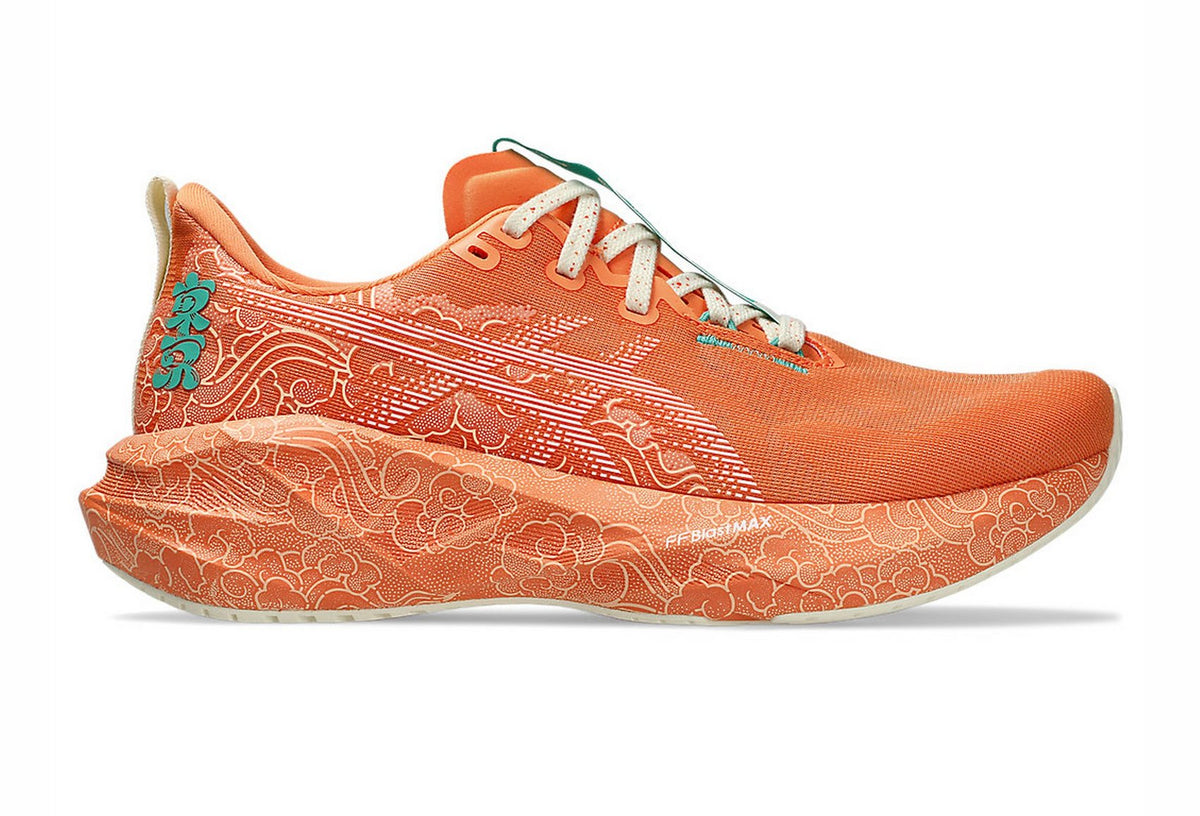 Side view on white background of Womens Asics Novablast 5 running shoe in Sun Peach/White, Wide width