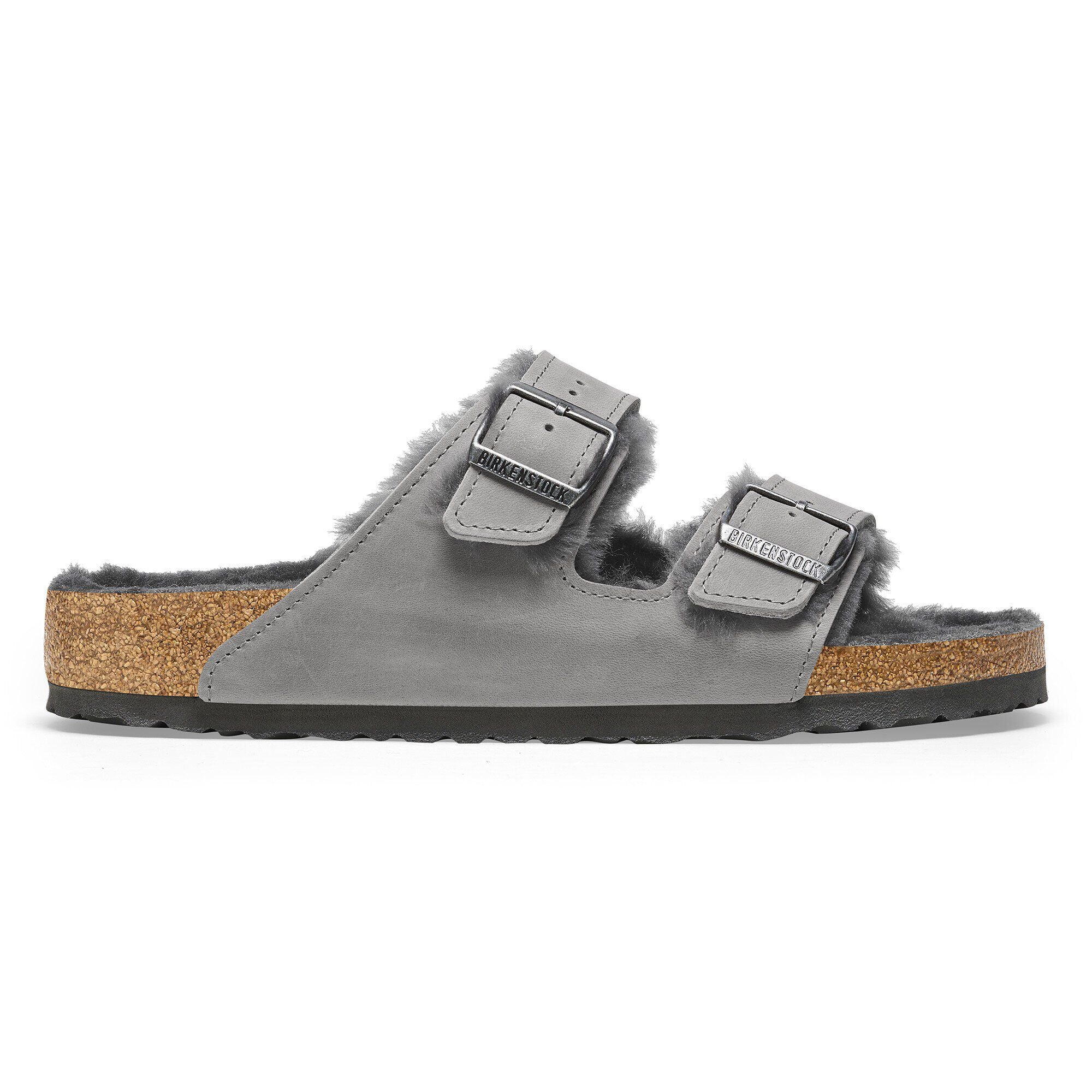 Side view on white background of Womens Birkenstock Arizona Shearling running shoe in Iron, Narrow width