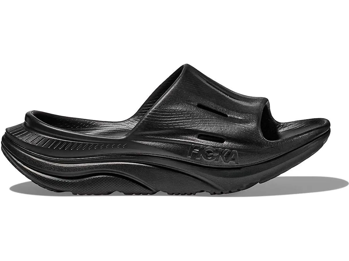 Side view on white background of Womens Hoka Ora Recovery Slide 3 running shoe in Black, Medium (Regular) width