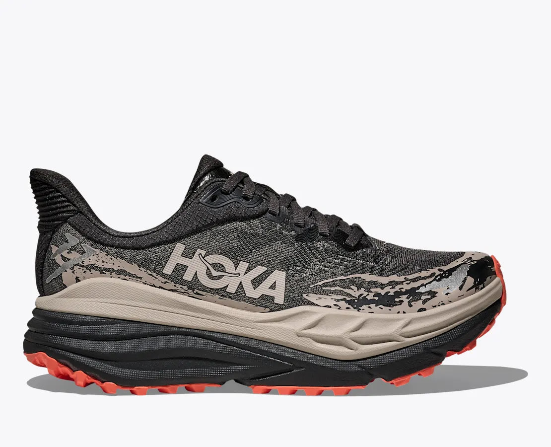Side view on white background of Womens Hoka Stinson 7 running shoe in Black/Putty, Medium (Regular) width