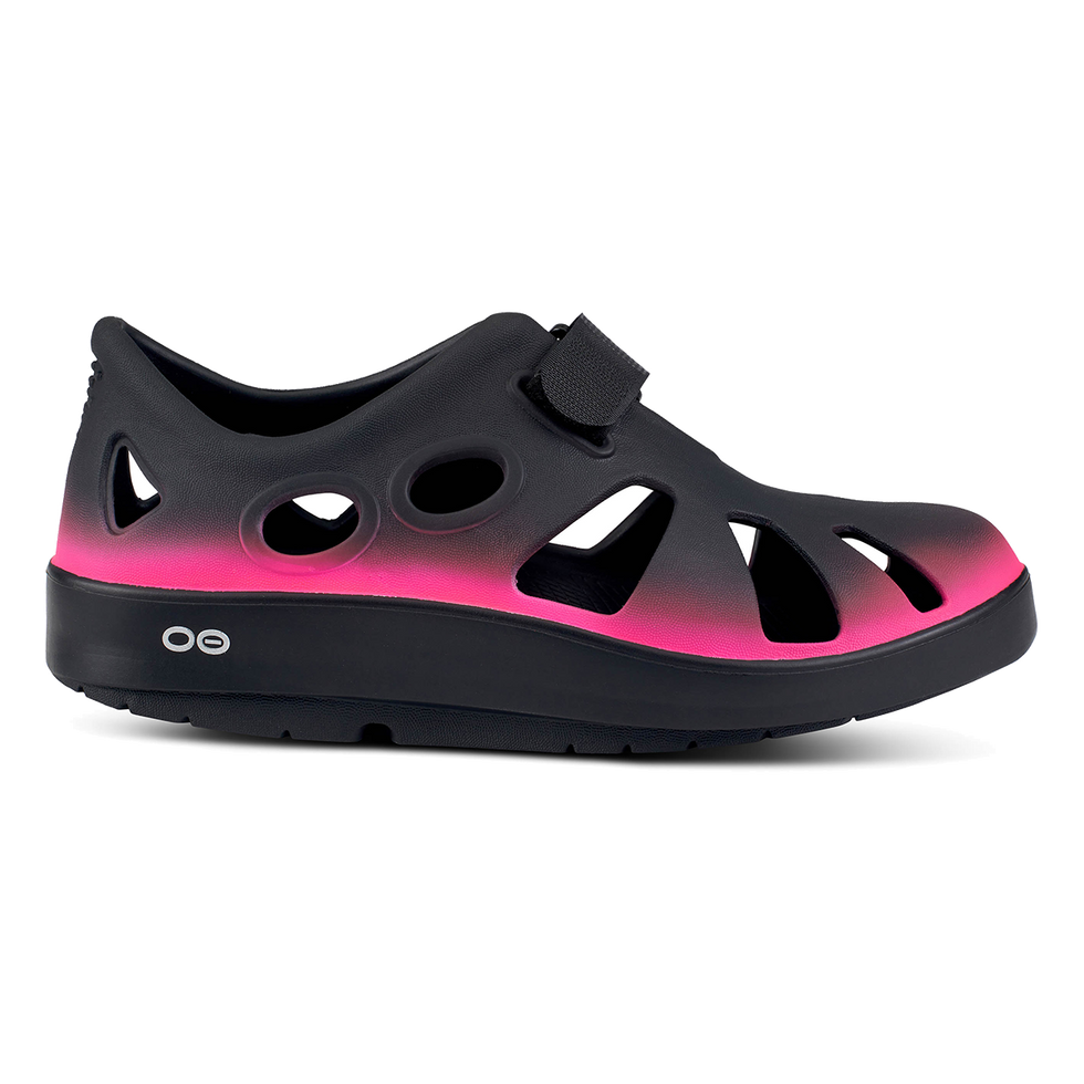 Side view on white background of Womens OOFOS OOcandoo running shoe in Pink, Medium (Regular) width