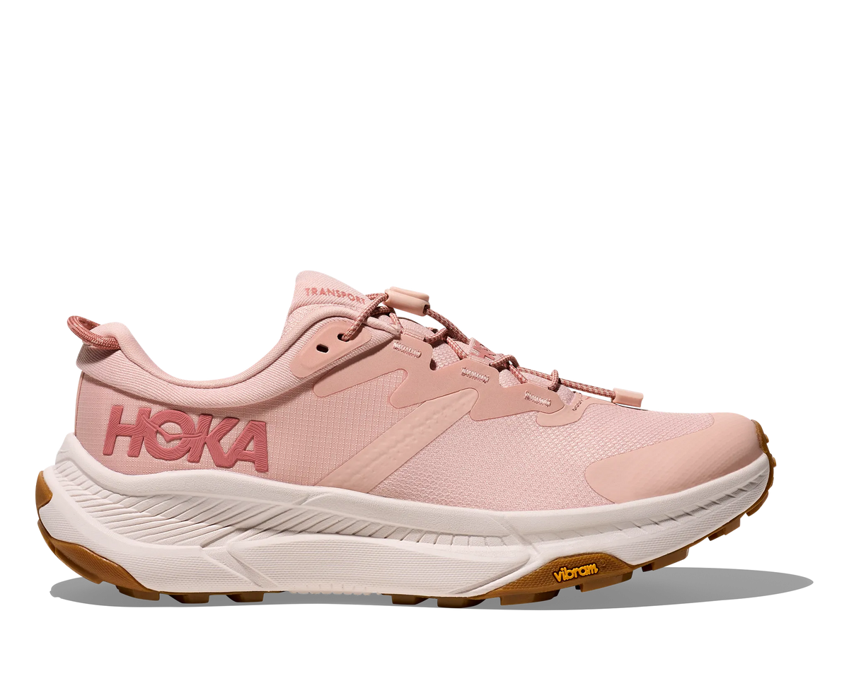 Side view on white background of Womens Hoka Transport running shoe in Rose Latte/Rose Cream, Medium (Regular) width
