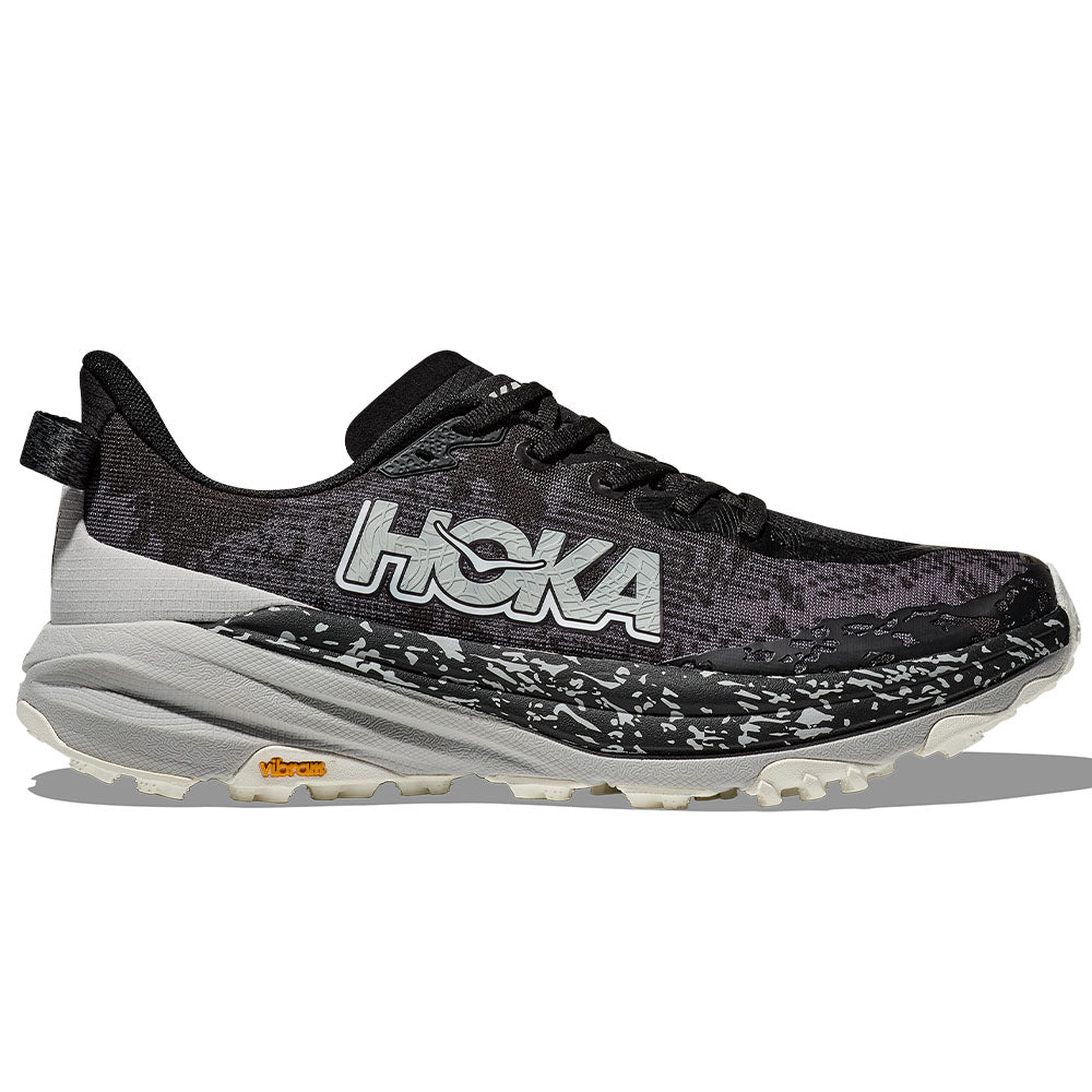 Side view on white background of Mens Hoka Speedgoat running shoe in Black/Stardust, Medium (Regular) width