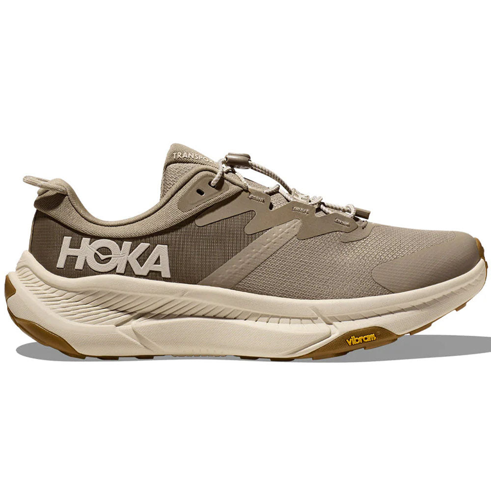 Side view on white background of Mens Hoka Transport running shoe in Dune/Eggnog, Medium (Regular) width