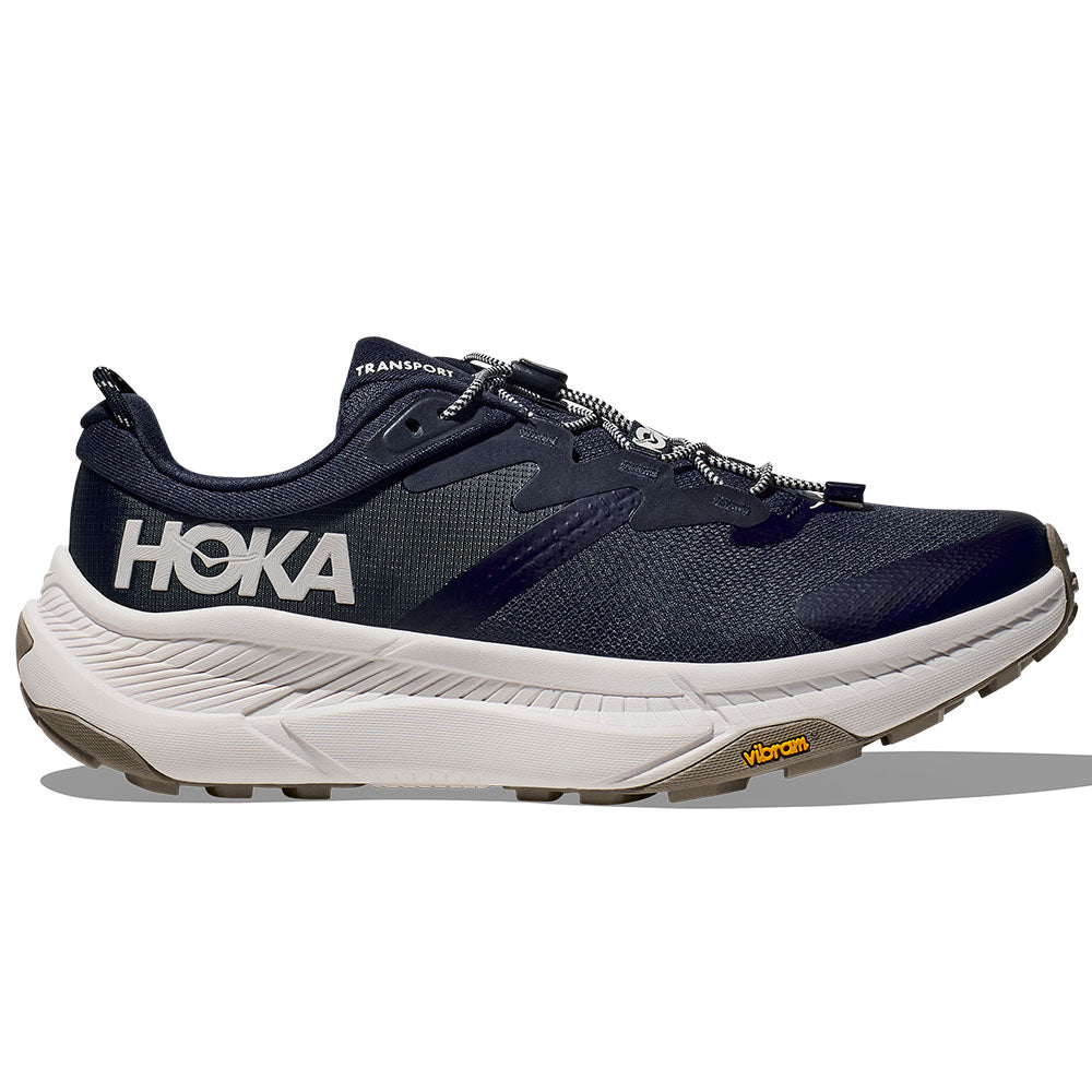 Side view on white background of Mens Hoka Transport running shoe in Varsity Navy/White, Medium (Regular) width