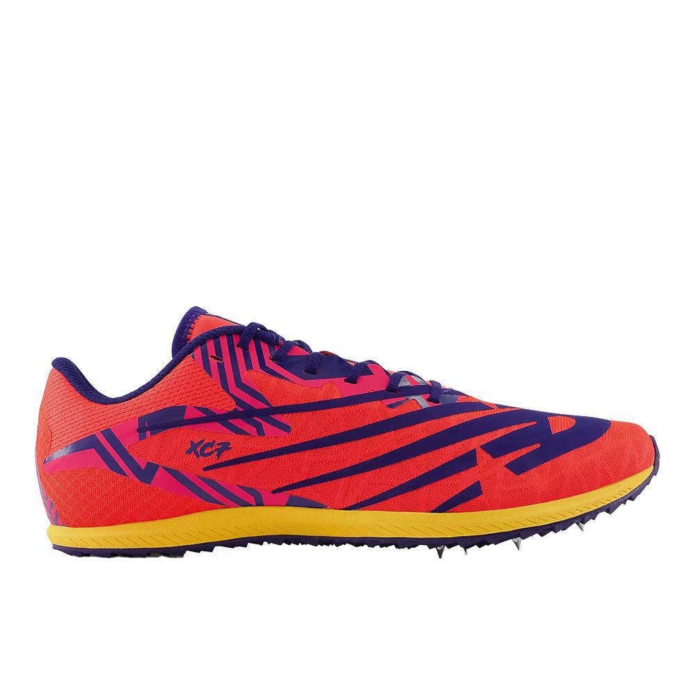 Side view on white background of Mens New Balance XC Seven V4 running shoe in Electric Red/Victory Blue, Medium (Regular) width