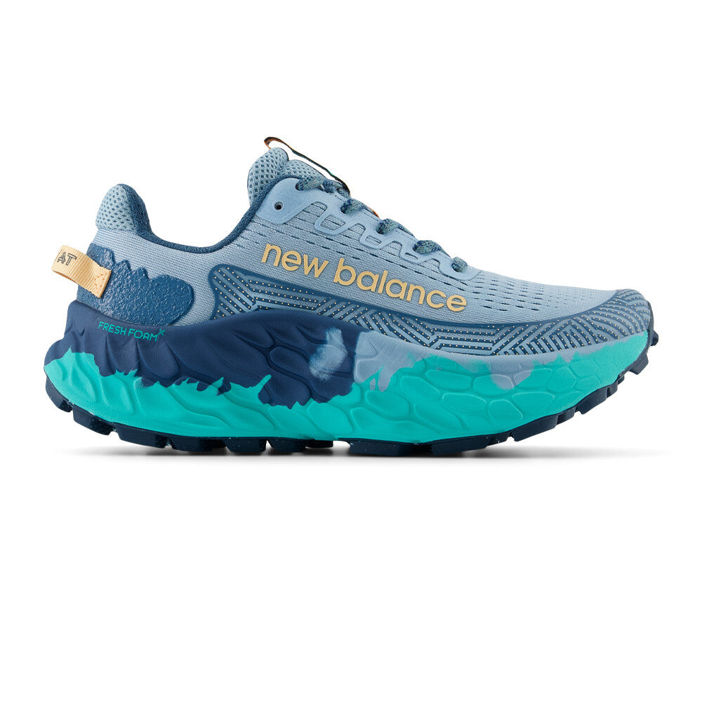 Side view on white background of Womens New Balance Fresh Foam More Trail V3 running shoe in Chrome Blue/Terrarium/Peach Blossom, Wide width