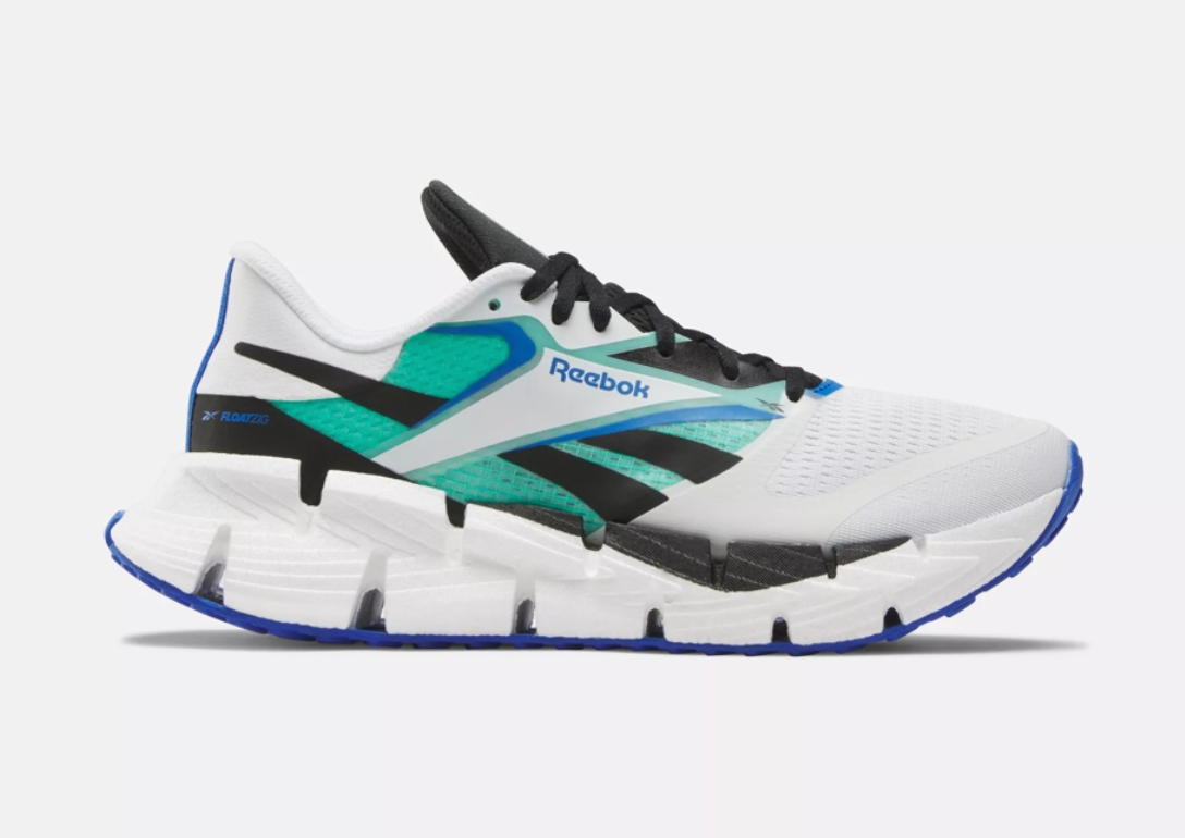 Side view on white background of Mens Reebok Floatzig 1 running shoe in White/Black/Cyber Mint, Medium (Regular) width