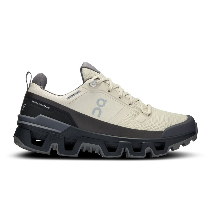 Side view on white background of Womens On Cloudwander Waterproof running shoe in Sand/Black, Medium (Regular) width