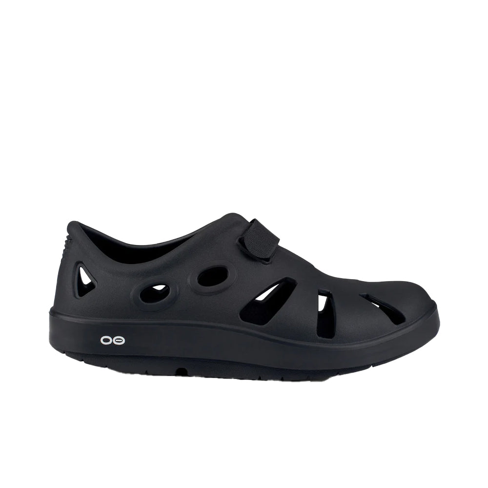 Side view on white background of Mens OOFOS OOCandoo running shoe in Black, Medium (Regular) width