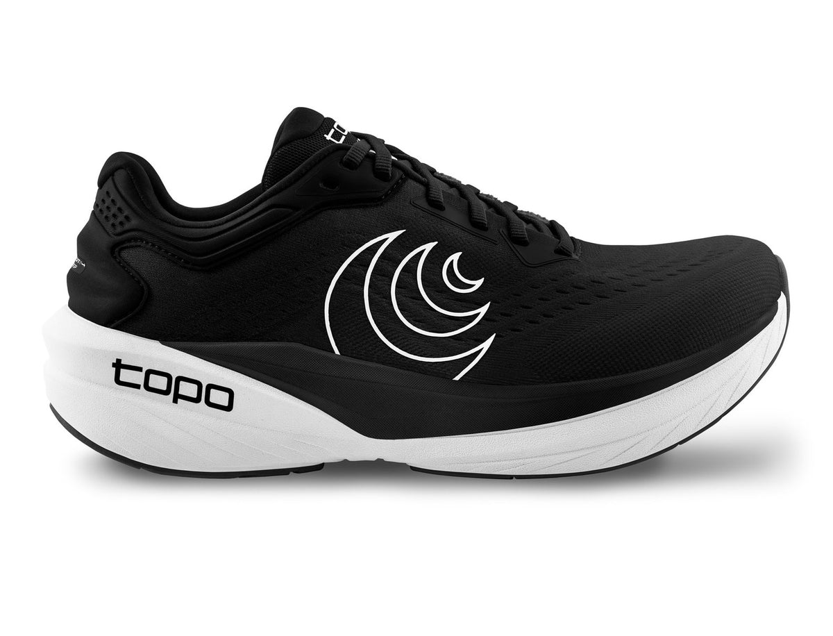 Side view on white background of Womens Topo Athletic Phantom 4 running shoe in Black/White, Medium (Regular) width