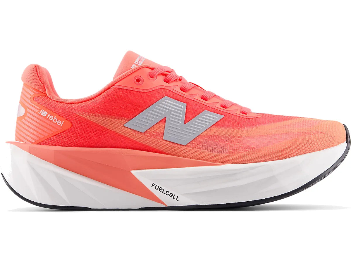 Side view on white background of Womens New Balance FuelCell Rebel v5 running shoe in Urgent Red/White/Silver Metallic, Wide width