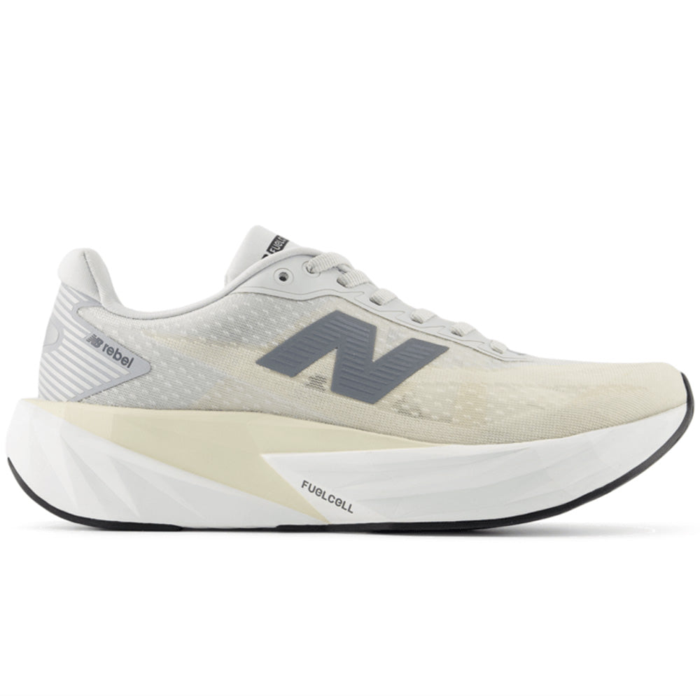 Side view on white background of Womens New Balance FuelCell Rebel running shoe in Linen/Grey Matter/White, Wide width