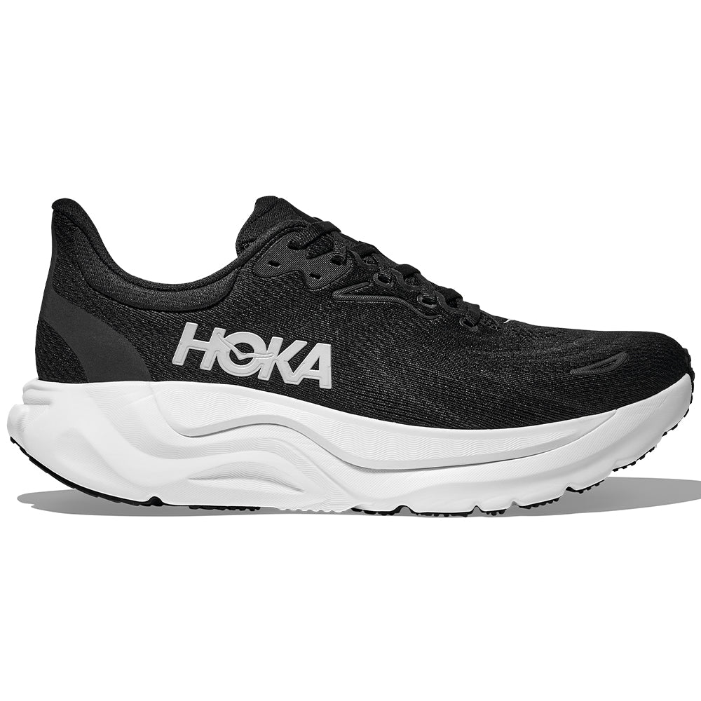 Side view on white background of Womens Hoka Arahi running shoe in Black/White, Medium (Regular) width