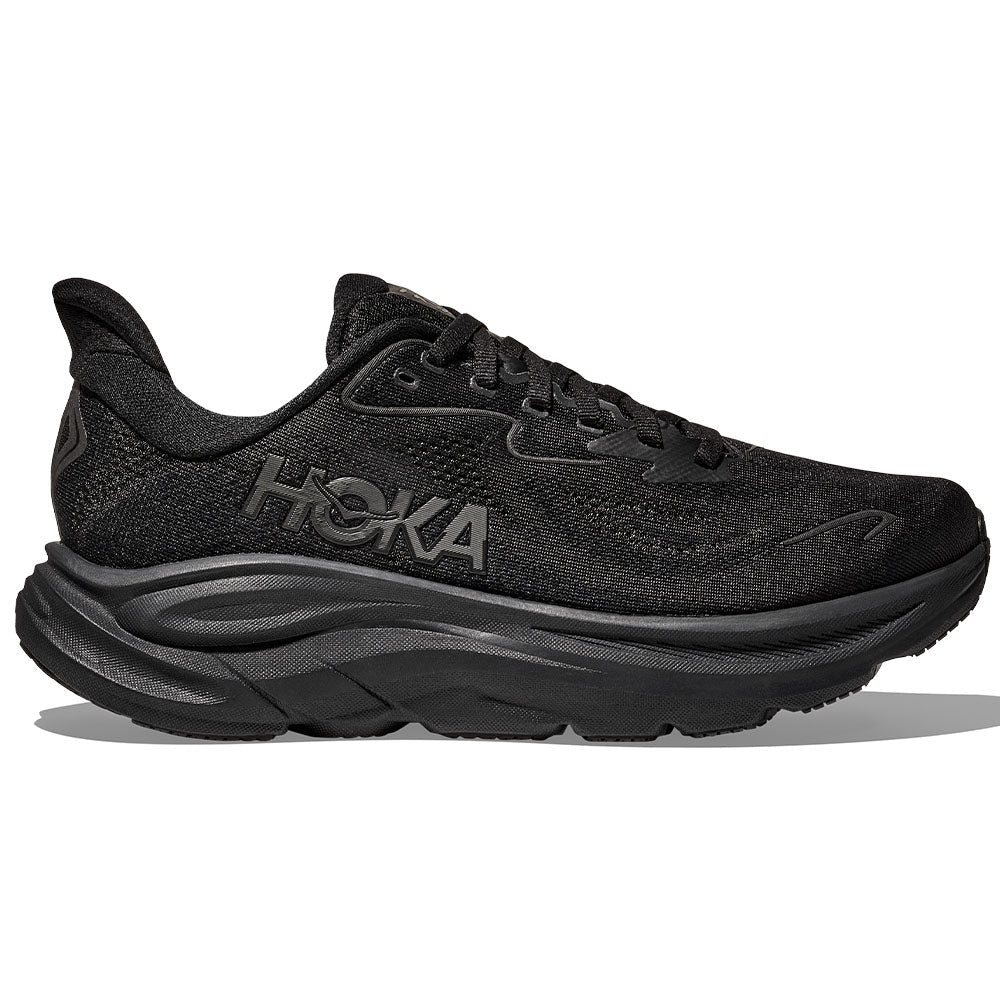 Side view on white background of Womens Hoka Clifton running shoe in Black/Black, Extra Wide width