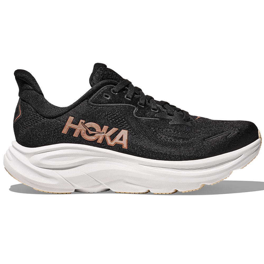 Side view on white background of Womens Hoka Clifton running shoe in Black/Rose Gold, Medium (Regular) width