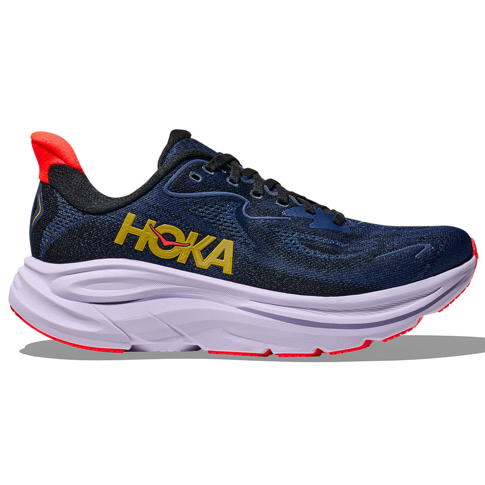Side view on white background of Womens Hoka Clifton running shoe in Midnight Blue/Starlight Glow, Wide width