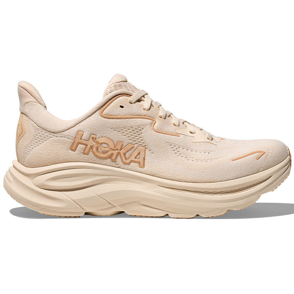 Side view on white background of Womens Hoka Clifton running shoe in Vanilla/Birch, Medium (Regular) width