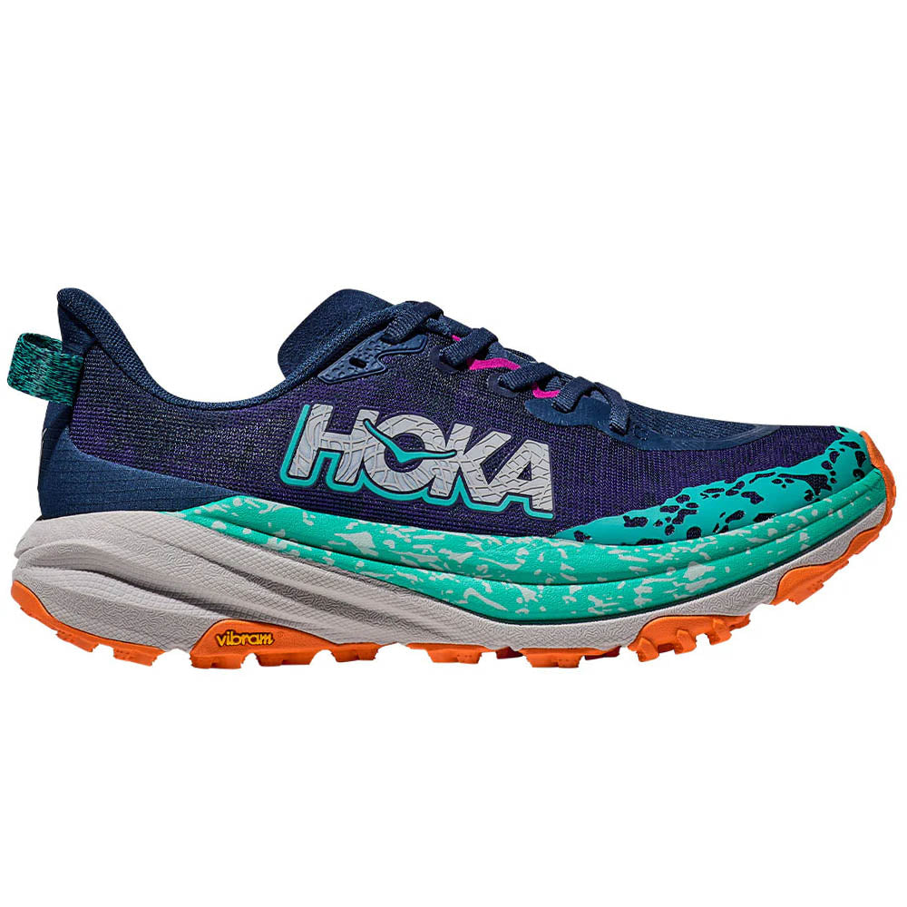 Side view on white background of Womens Hoka Speedgoat running shoe in Varsity Navy/Meteor, Medium (Regular) width