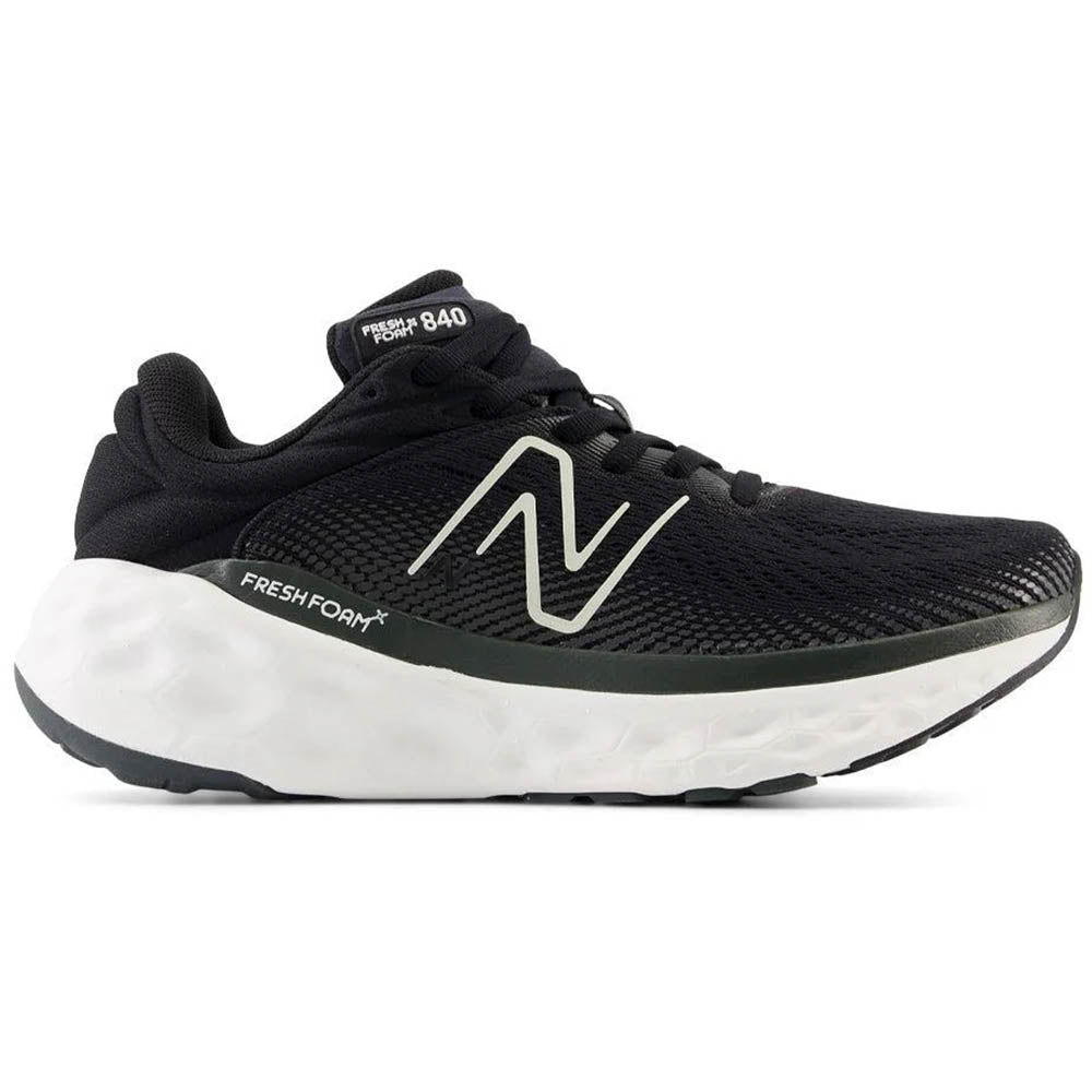 Side view on white background of Womens New Balance Fresh Foam X 840 running shoe in Black/Magnet, Extra Wide width