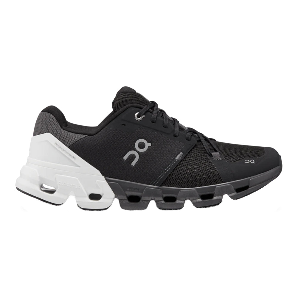 Side view on white background of Womens On Cloudflyer 4 running shoe in Black/White, Wide width