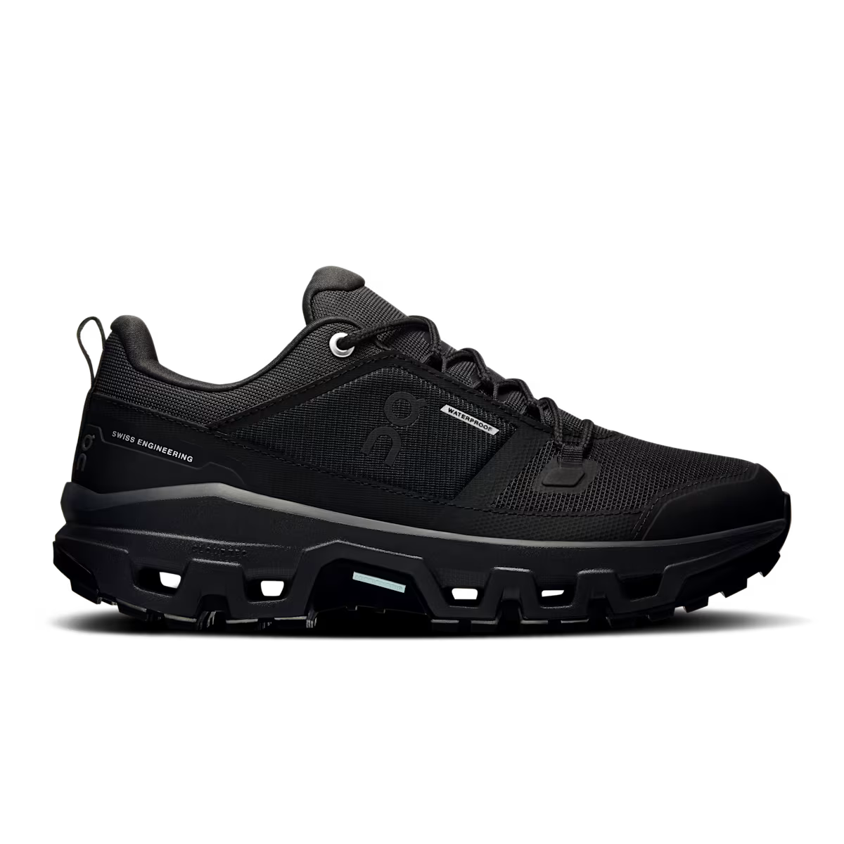 Side view on white background of Womens On Cloudrock Low Waterproof running shoe in Black/Black, Medium (Regular) width