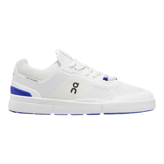Side view on white background of Womens On The Roger Spin 2 running shoe in White/Indigo, Medium (Regular) width